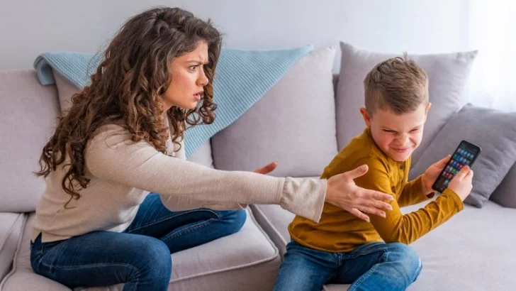 boy-plays-with-electronic-device-but-his-mother-not-happy-with-this-picture-id1133553398-1-728x410 consumo problemático digital