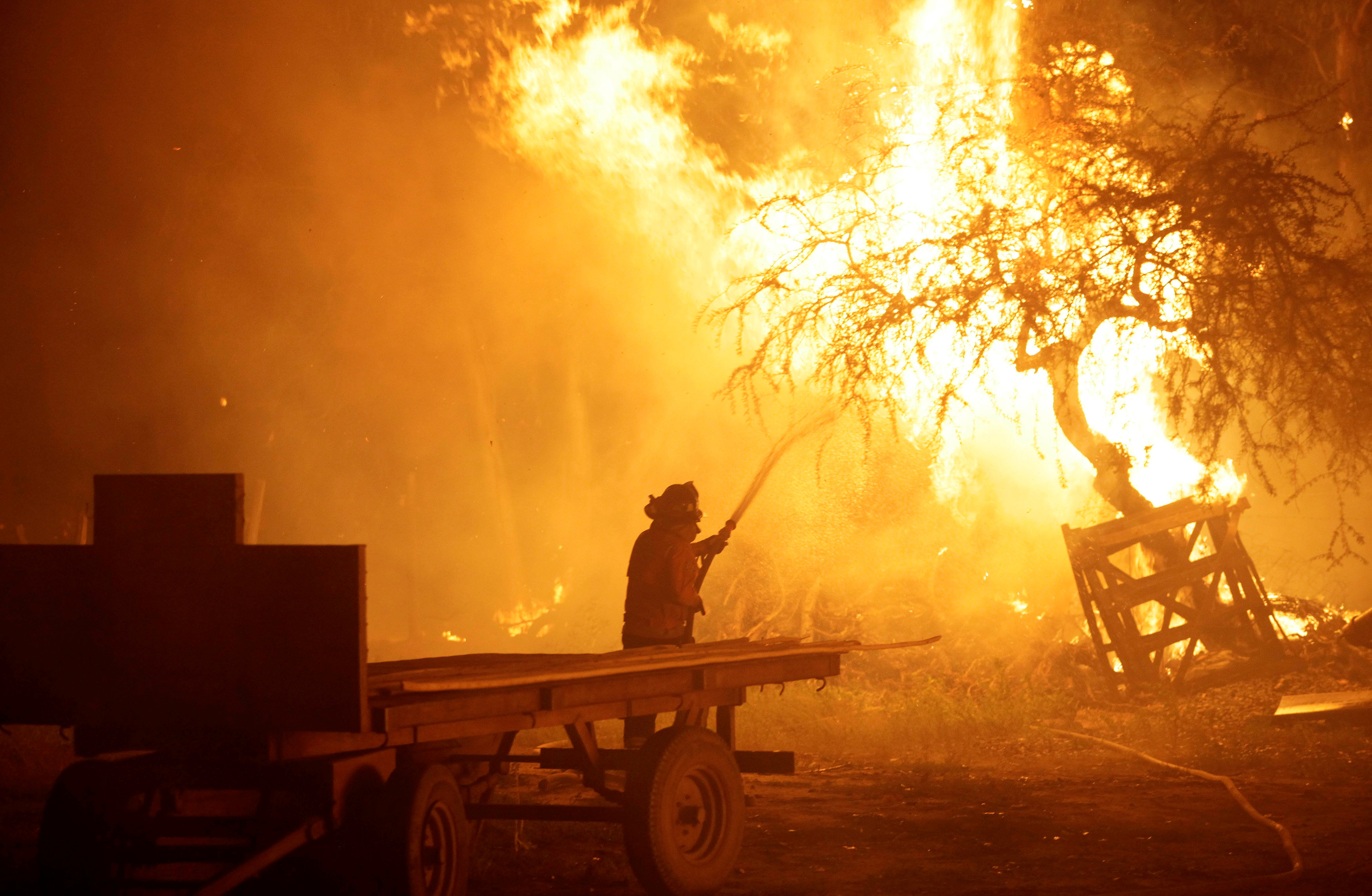 A firefighter tries to stop wildfires in Chile's central-south regions, in Portezuelo - NARCH/NARCH30