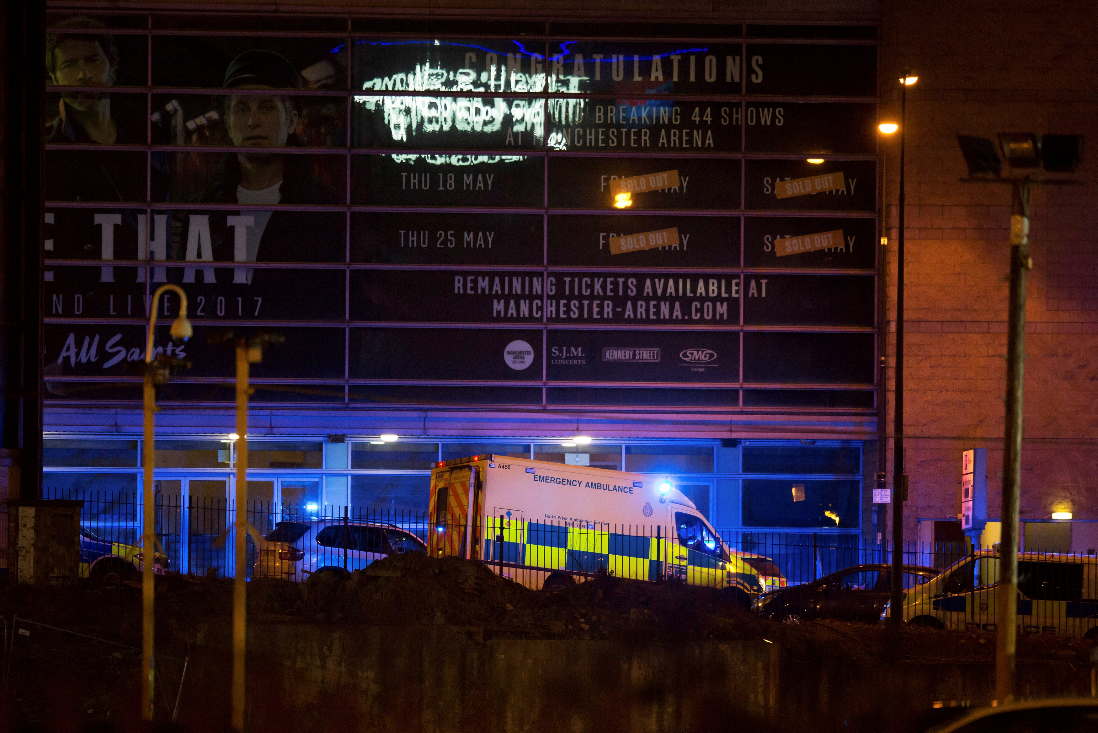 A police van and an ambulance are seen outside the Manchester Arena, where U.S. singer Ariana Grande had been performing, in Manchester