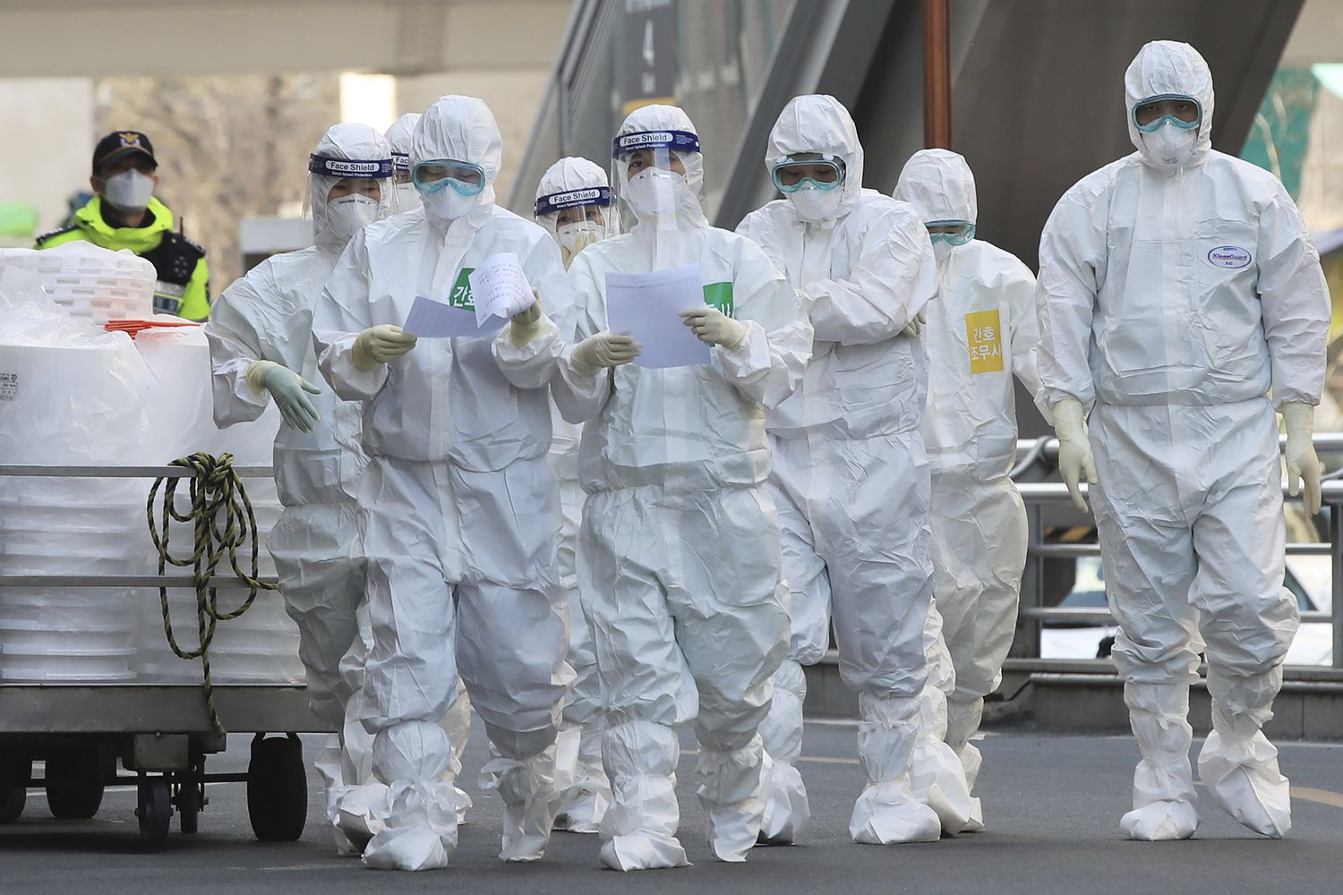 Medical staff members arrive for a duty shift at Dongsan Hospital in Daegu, South Korea, Tuesday, March 24, 2020. For most people, the new coronavirus causes only mild or moderate symptoms, such as fever and cough. For some, especially older adults and people with existing health problems, it can cause more severe illness, including pneumonia.(Han Jong-chan/Yonhap via AP)